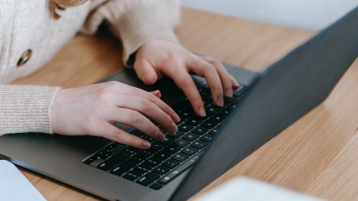 Hands on laptop keyboard