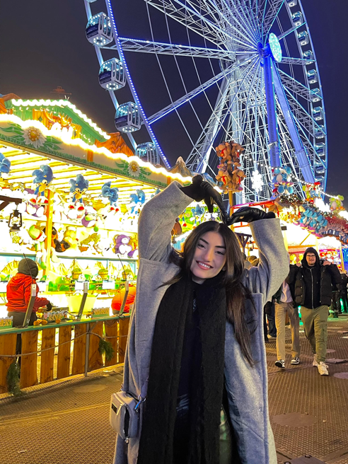 Student Shahad in front of the London Eye at night