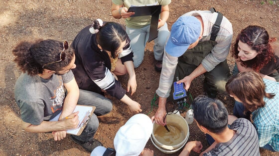 Group of bachelor of environmental science honours students performing field research.
