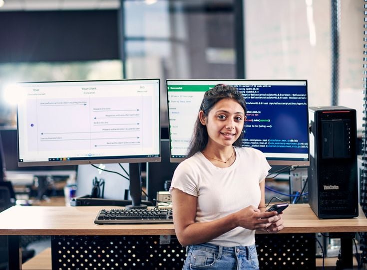 Person standing in front of computers