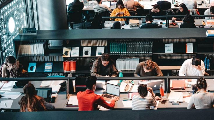 Busy students studying in a big library