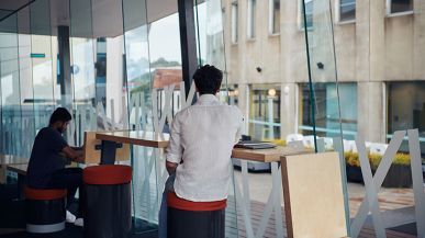 Students sitting and studying at high desk - Burwood Campus students