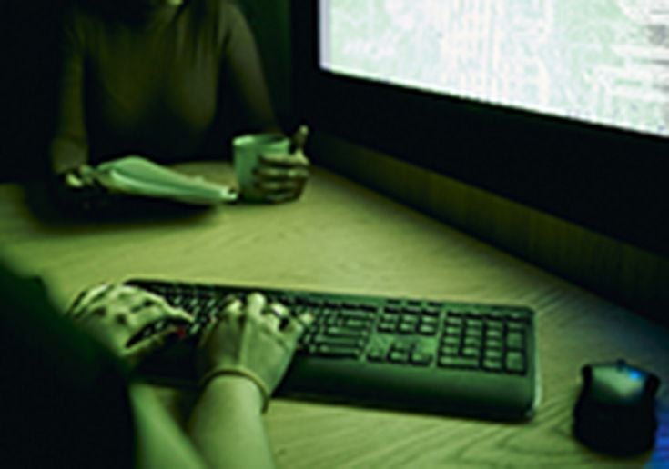 two students viewing computer at night