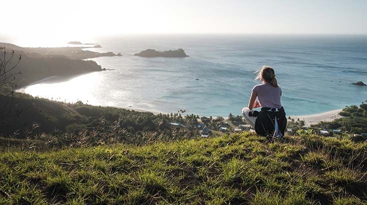 Person overlooking sea on hill in Fiji