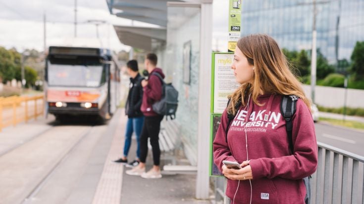 Student waiting at tram stop