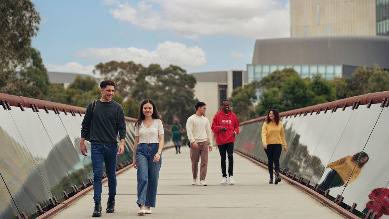 Students walk across a bridge at Deakin's Melbourne Burwood Campus.