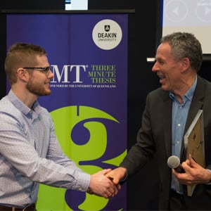 Deputy Vice-Chancellor Global Engagement Professor Gary Smith (right) presents Deakin’s 3MT winner, Jarrod Hogan with his award. 