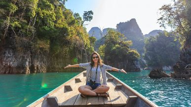 Student on boat smiling at camera