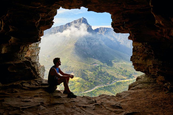 man in cave on mountain