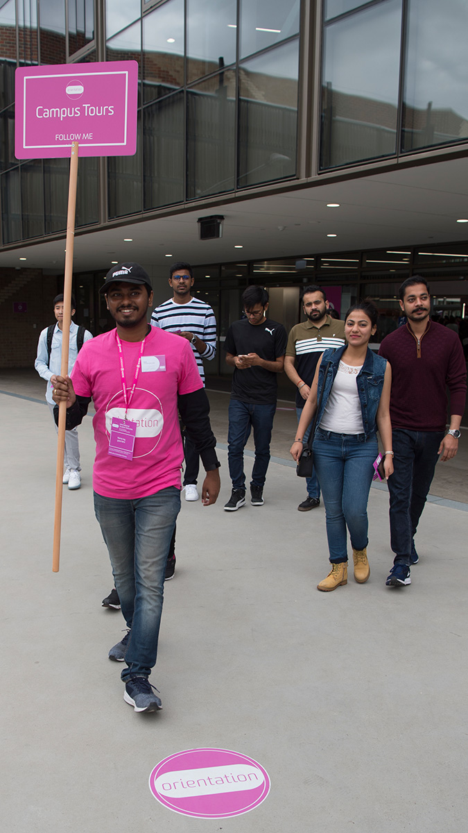 student ambassador leading an on campus tour for international students