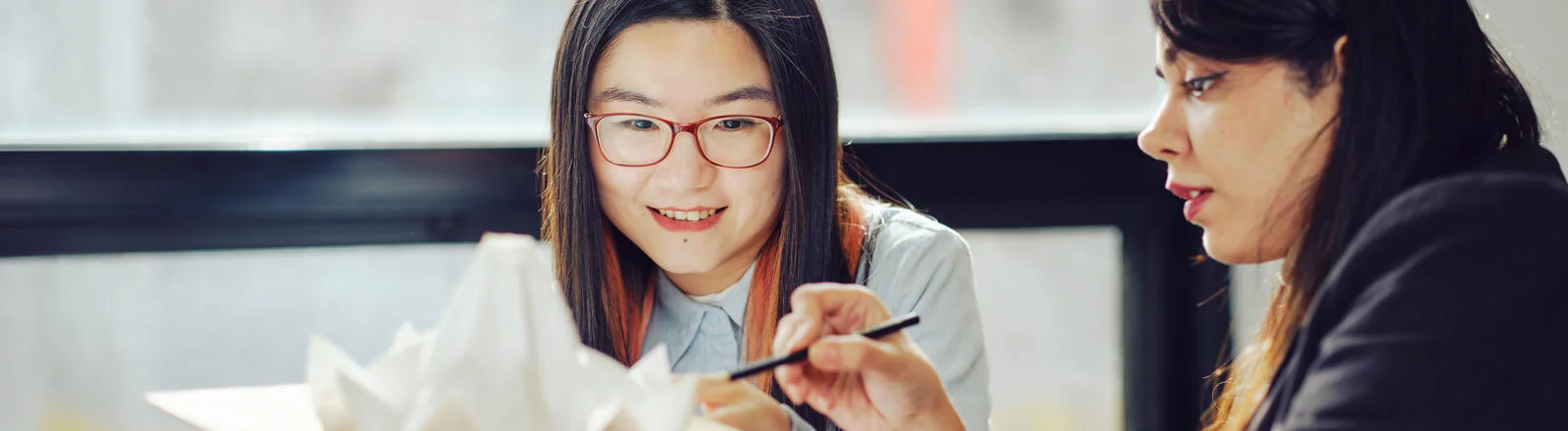 Two bachelor of design architecture / master of architecture students work together on campus.