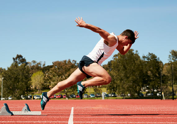 A person starting a sprint on an athletics track
