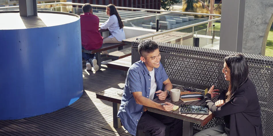 A group of Deakin students studying at an outdoor table