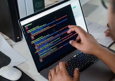 IT student looking at coding on computer