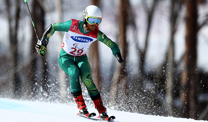 Mitchell Gourley skiing downhill in competition