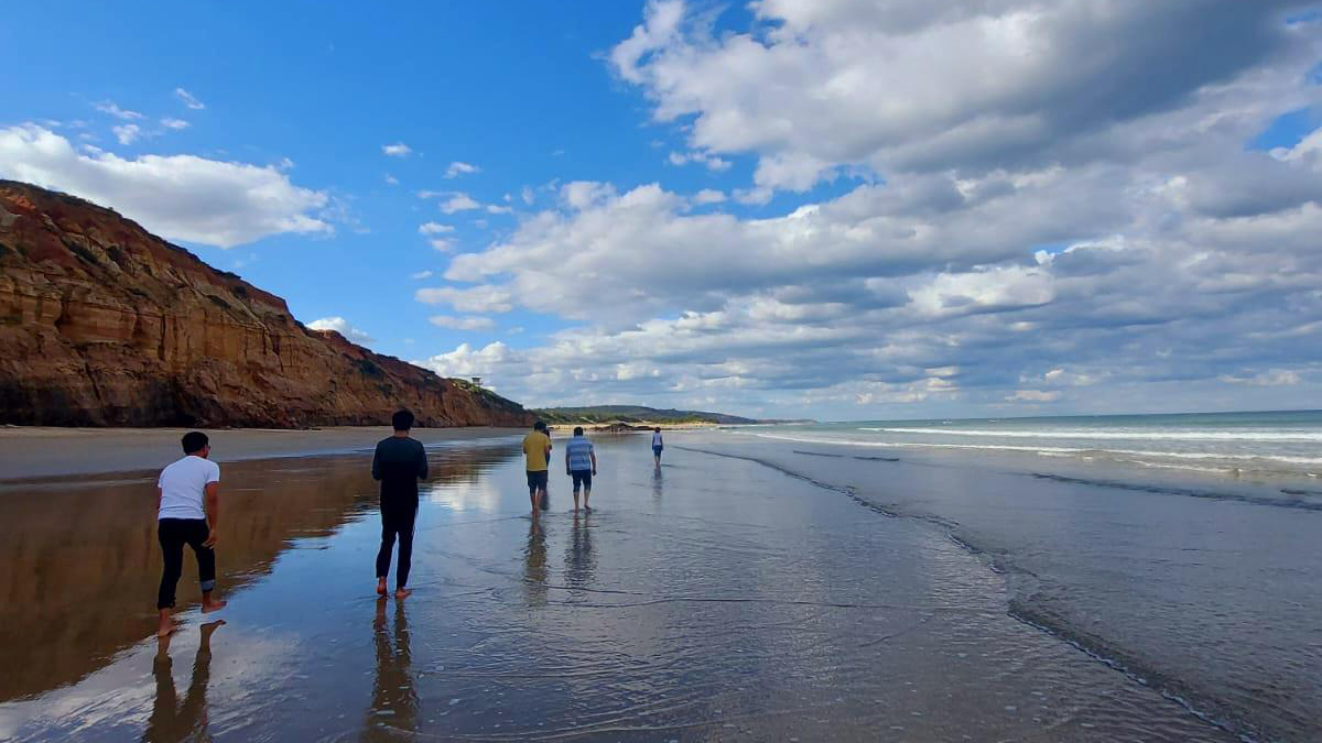 Students walking along Surfcoast beach