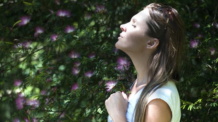 Person in nature with eyes closed