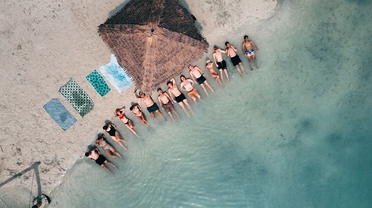 Group of students laying on beach in Indonesia