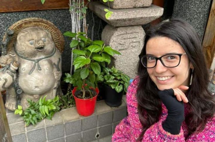 Alina next to a small shrine in Japan