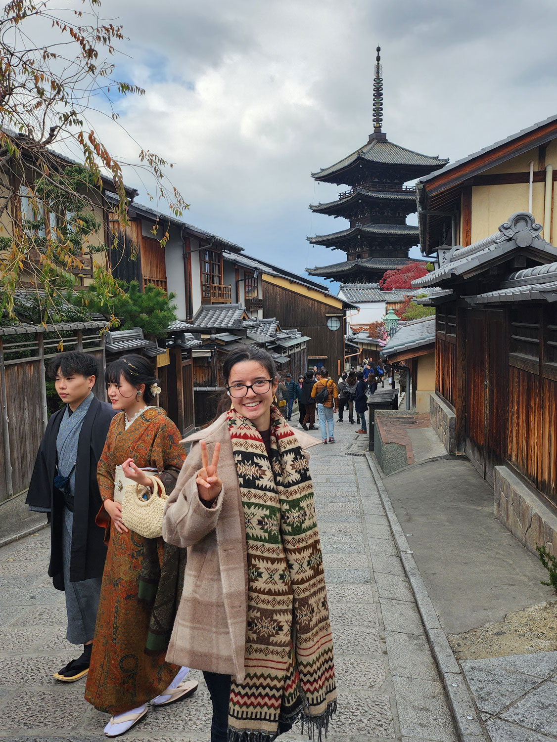 Alina walking the streets of Japan with a temple in the background