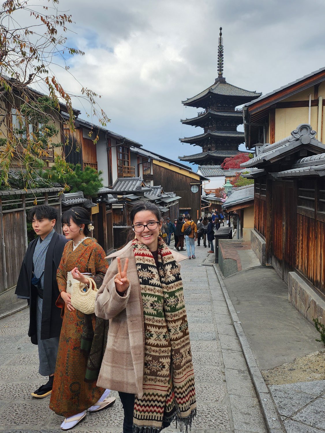 Alina walking the streets of Japan with a temple in the background