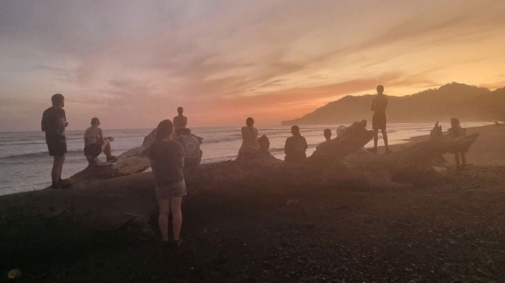 Students on a beach in Costa Rica at dawn