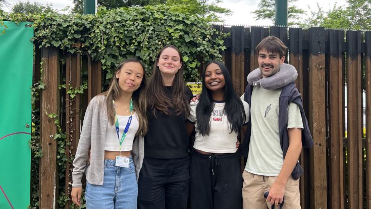 Ethan and friends stand in front of the University of Roehampton sign