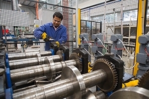 Researcher working on a pilot scale roll former at Deakin University.