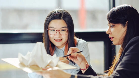 Two bachelor of design architecture / master of architecture students work together on campus.