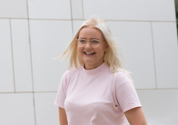 Person laughing with hands behind themself