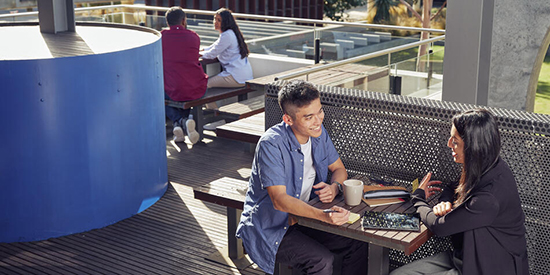 A group of Deakin students studying at an outdoor table