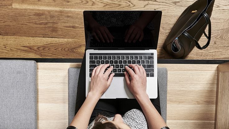 Student sits with laptop on the desk