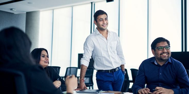 Students around a table in business discussion