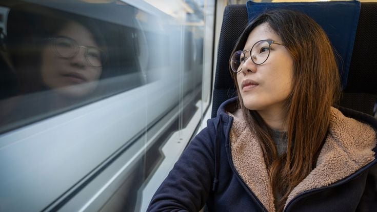 Student on train staring out of the window.