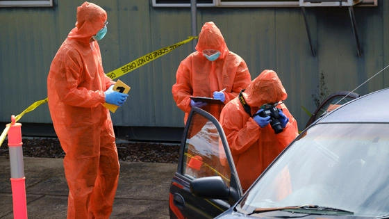 Forensic Science students photographing and examining evidence at a crime scene