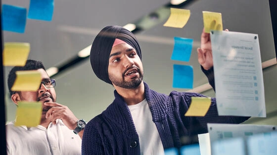Two Deakin master of information systems students work together on campus.