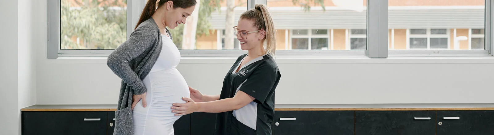 Deakin graduate diploma of midwifery student nurse performs check on pregnant woman in a clinical setting.