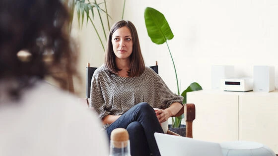 Deakin graduate diploma of mental health nursing student in office talking to others.