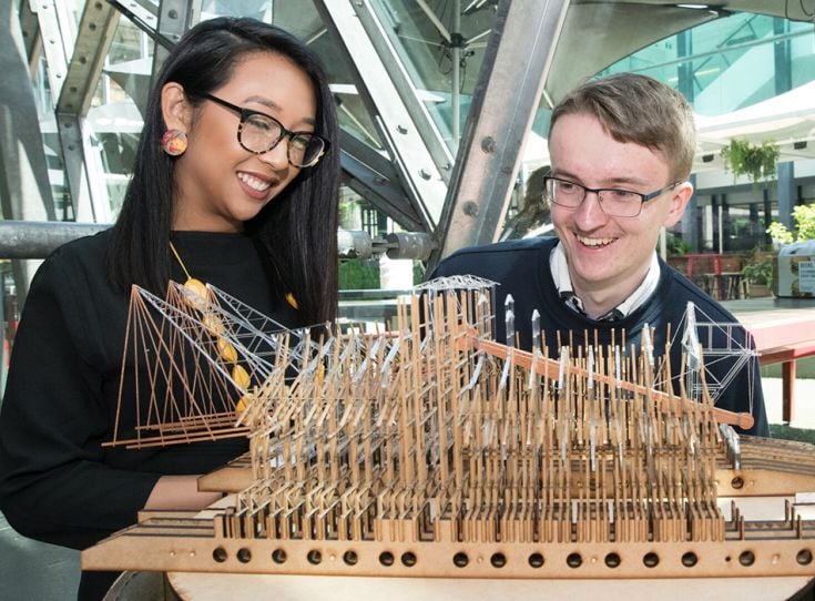 Two students looking at architectural model