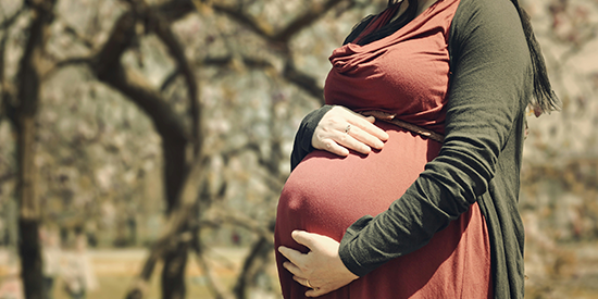 Pregnant woman holding her baby bump