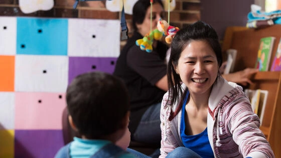 Deakin bachelor of early childhood education student teacher in kindergarten playing with child.