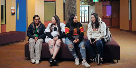 Four Deakin students sit inside the NIKERI Institute at the Waurn Ponds Campus.