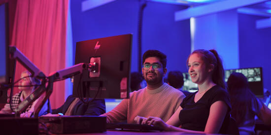 Two Cybersecurity students Looking at Computer Screen