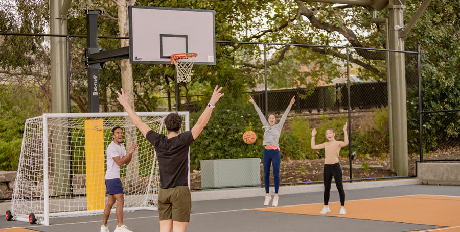A group of Deakin Res students play basketball on the Burwood residential campus