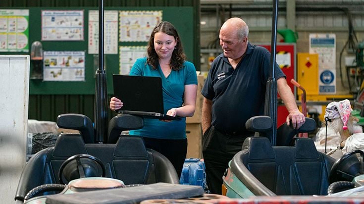 Business owner mentoring female engineer