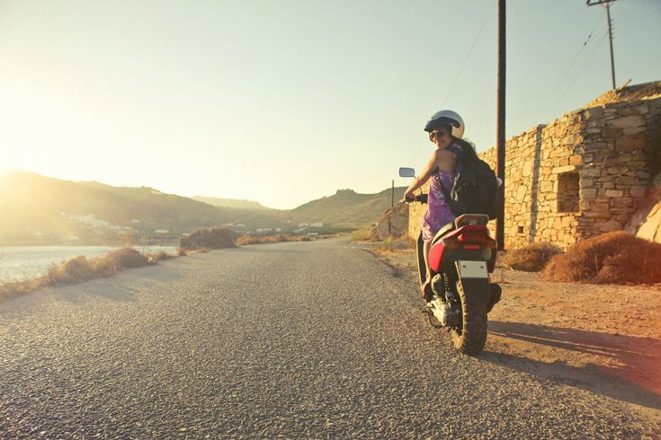 female student on motorbike smiling