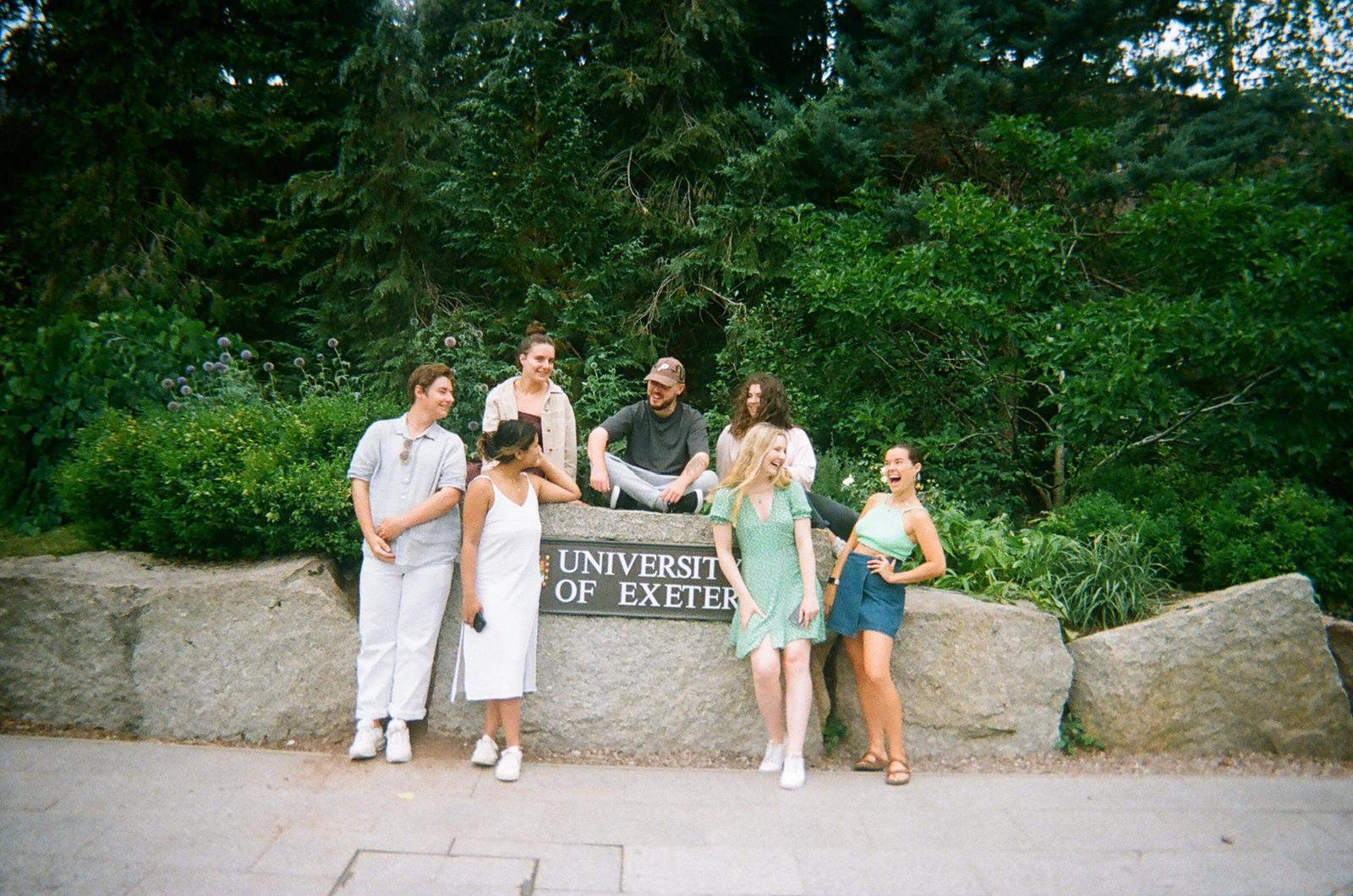 Group of students including Deakin student around Exeter sign