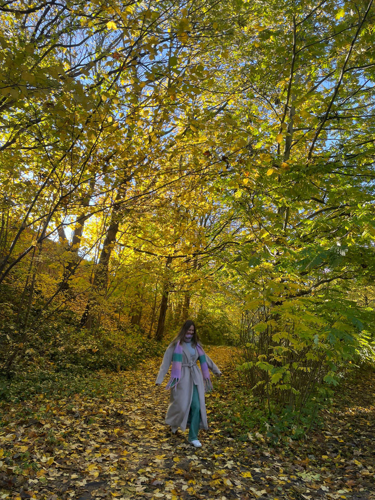 Student Chloe surrounded by large trees