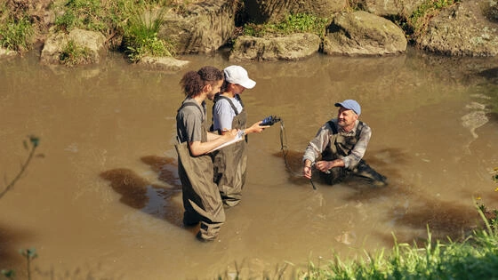 Deakin environmental science students test water in a creek.