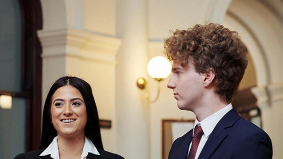 Law students stand and chat at Supreme Court of Victoria.